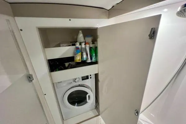 Amihan Yacht Photos Pics Laundry area with washing machine and storage in 2023 Fountaine Pajot Isla 40 yacht.