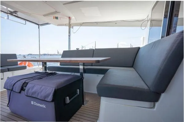 Amihan Yacht Photos Pics 2023 Fountaine Pajot Isla 40 yacht interior with seating and table, featuring a Dometic cooler.