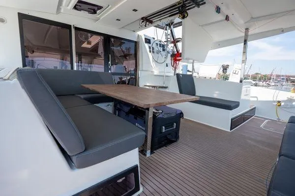 Amihan Yacht Photos Pics 2023 Fountaine Pajot Isla 40 catamaran interior with seating and table.