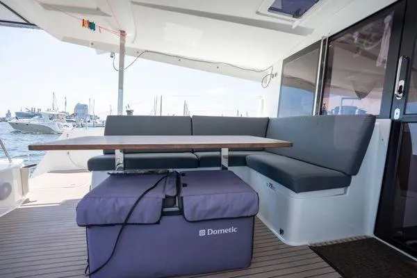 Amihan Yacht Photos Pics 2023 Fountaine Pajot Isla 40 yacht interior with seating and table, docked at marina.