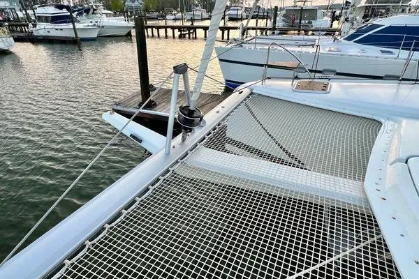 Amihan Yacht Photos Pics 2023 Fountaine Pajot Isla 40 catamaran docked at marina, featuring netted deck area.