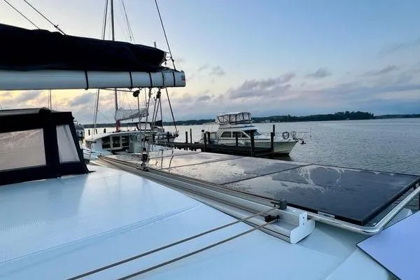 Amihan Yacht Photos Pics 2023 Fountaine Pajot Isla 40 catamaran docked at sunset with solar panels.