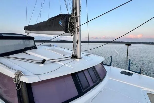 Amihan Yacht Photos Pics 2023 Fountaine Pajot Isla 40 catamaran on calm water at sunset.