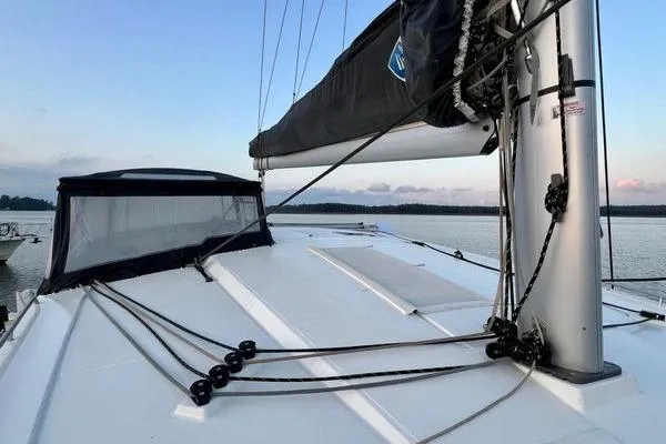Amihan Yacht Photos Pics 2023 Fountaine Pajot Isla 40 catamaran deck with mast and rigging at sunset.