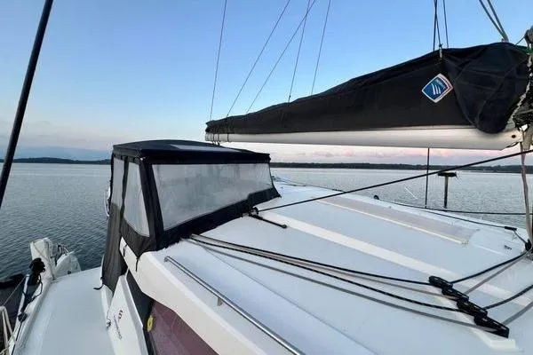 Amihan Yacht Photos Pics 2023 Fountaine Pajot Isla 40 catamaran on calm water at sunset.