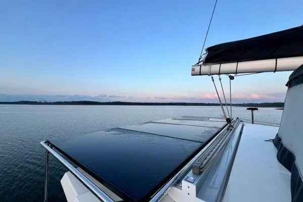 Amihan Yacht Photos Pics 2023 Fountaine Pajot Isla 40 catamaran sailing on calm waters at sunset.