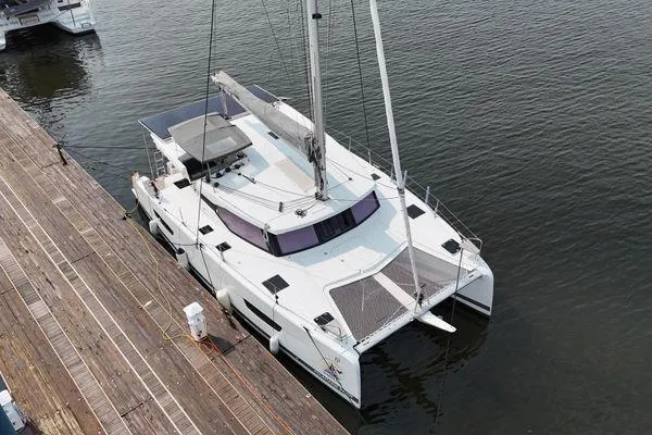 Amihan Yacht Photos Pics 2023 Fountaine Pajot Isla 40 catamaran docked at a marina, aerial view.