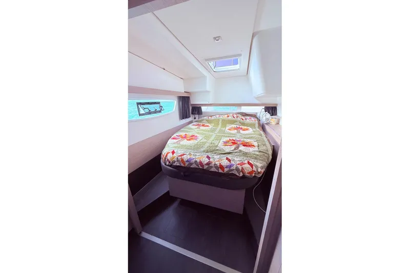 Amihan Yacht Photos Pics Luxurious cabin interior of 2023 Fountaine Pajot Isla 40 catamaran with colorful bedding.