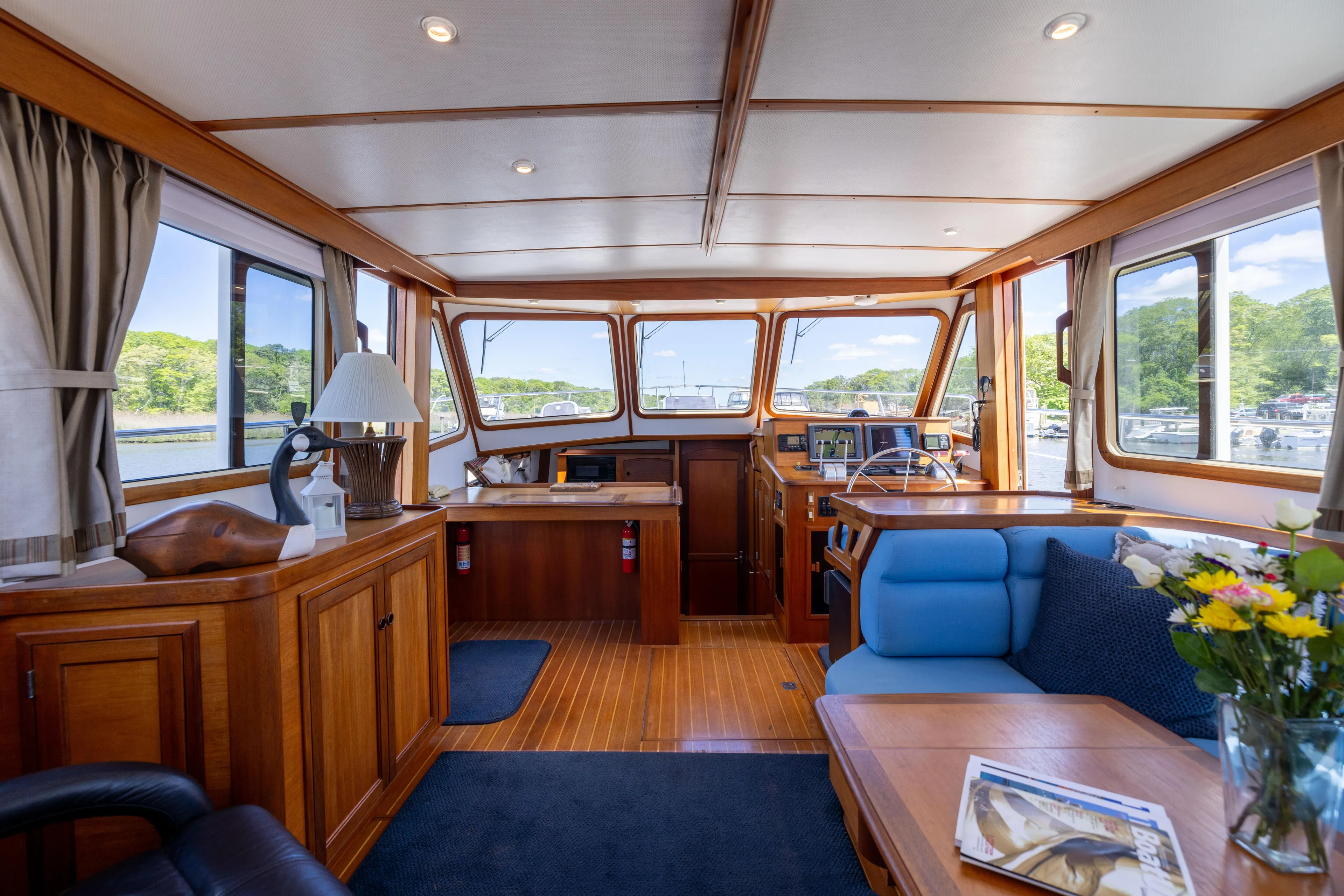 Nellie Yacht Photos Pics Interior of 1998 Sabreline 47 Aft Cabin Trawler with wood finish and blue seating.