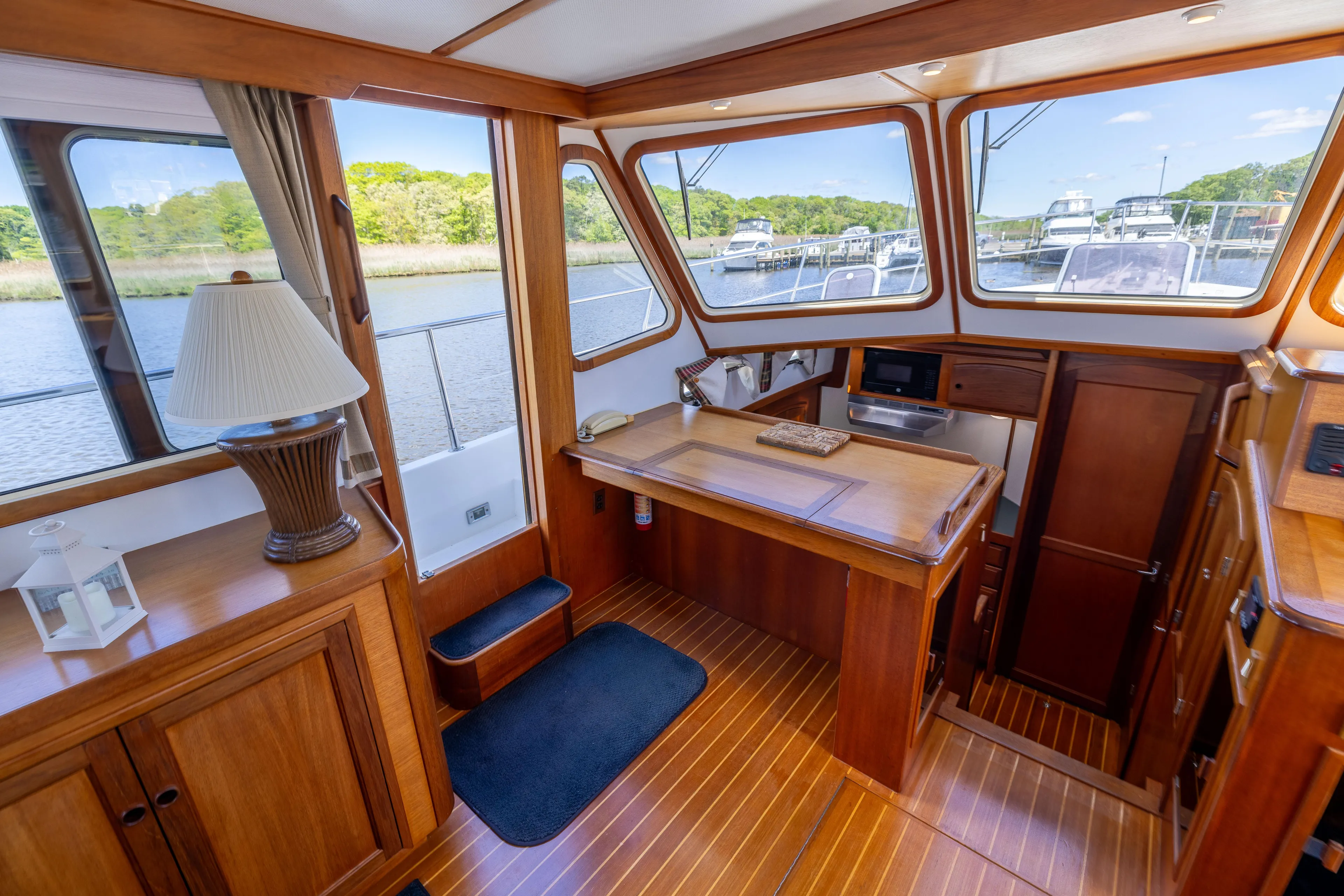 Nellie Yacht Photos Pics 1998 Sabreline 47 Aft Cabin Trawler interior with wood finish and waterfront view.