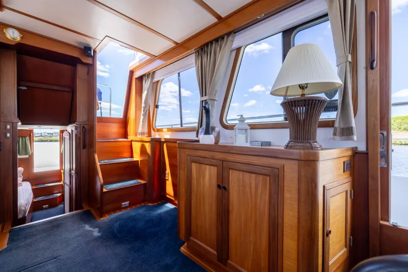 Nellie Yacht Photos Pics Interior of 1998 Sabreline 47 Aft Cabin Trawler with wooden cabinetry and nautical decor.