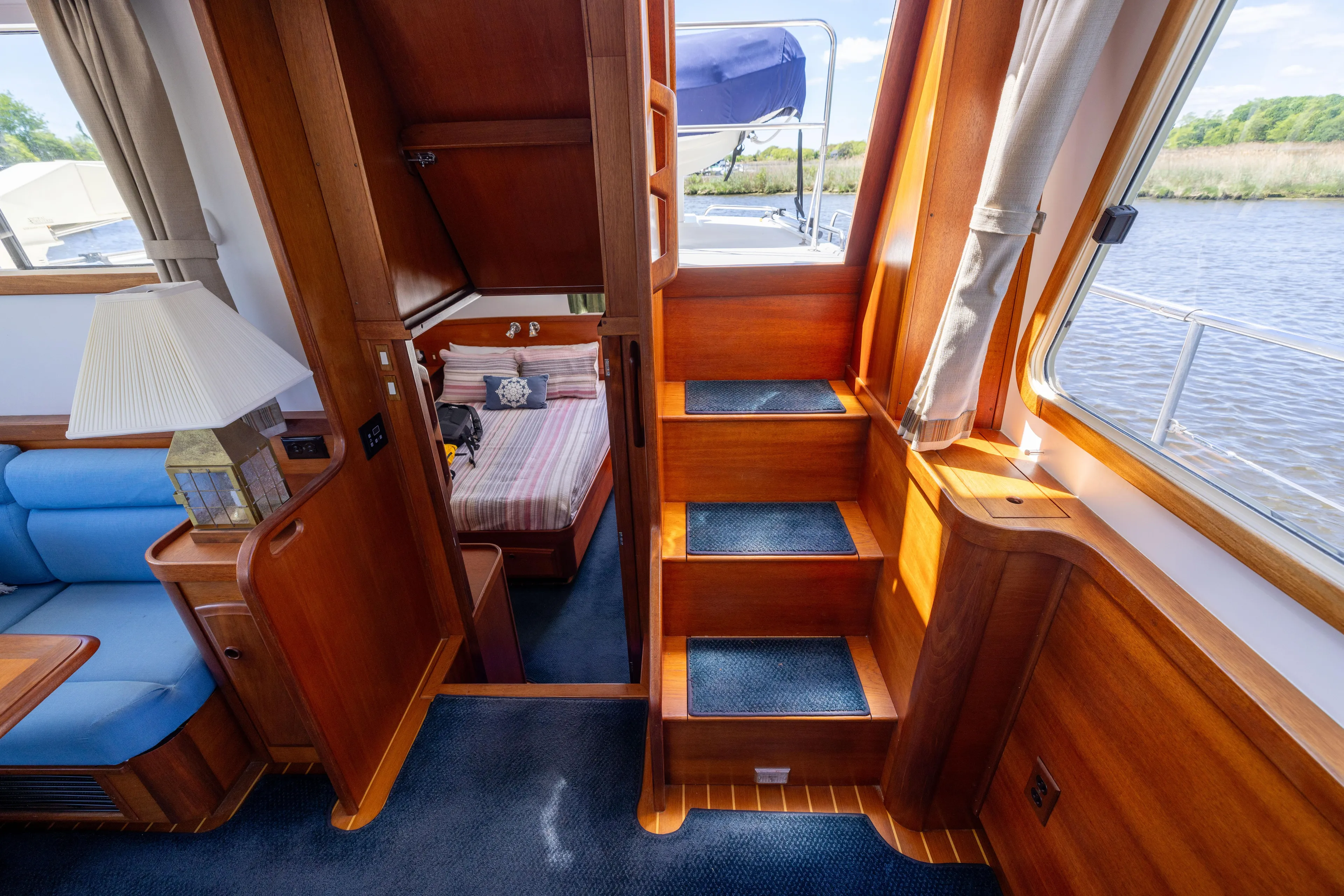 Nellie Yacht Photos Pics Interior of 1998 Sabreline 47 Aft Cabin Trawler with wooden stairs and cozy cabin view.