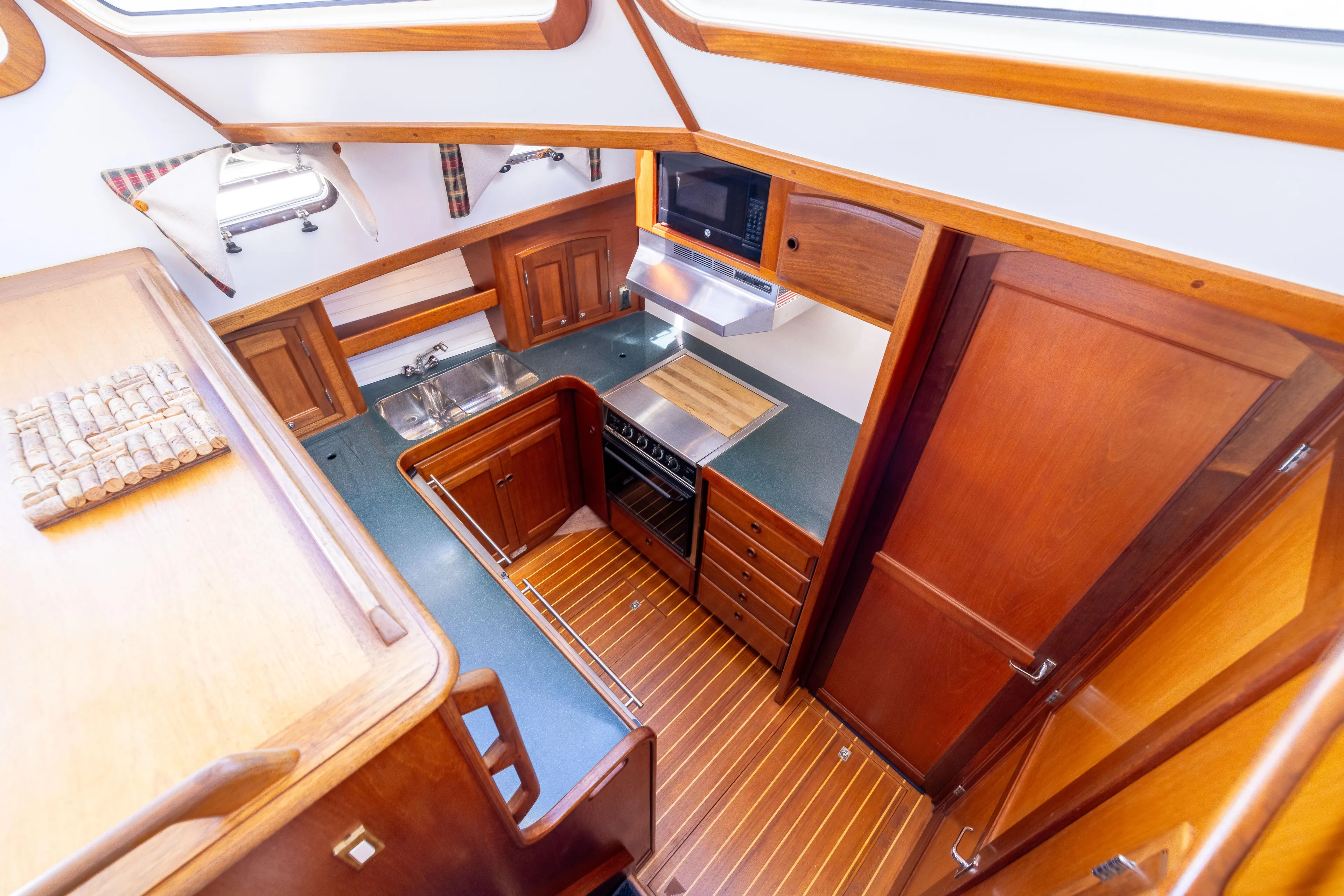 Nellie Yacht Photos Pics 1998 Sabreline 47 Aft Cabin Trawler kitchen with wood cabinetry and modern appliances.