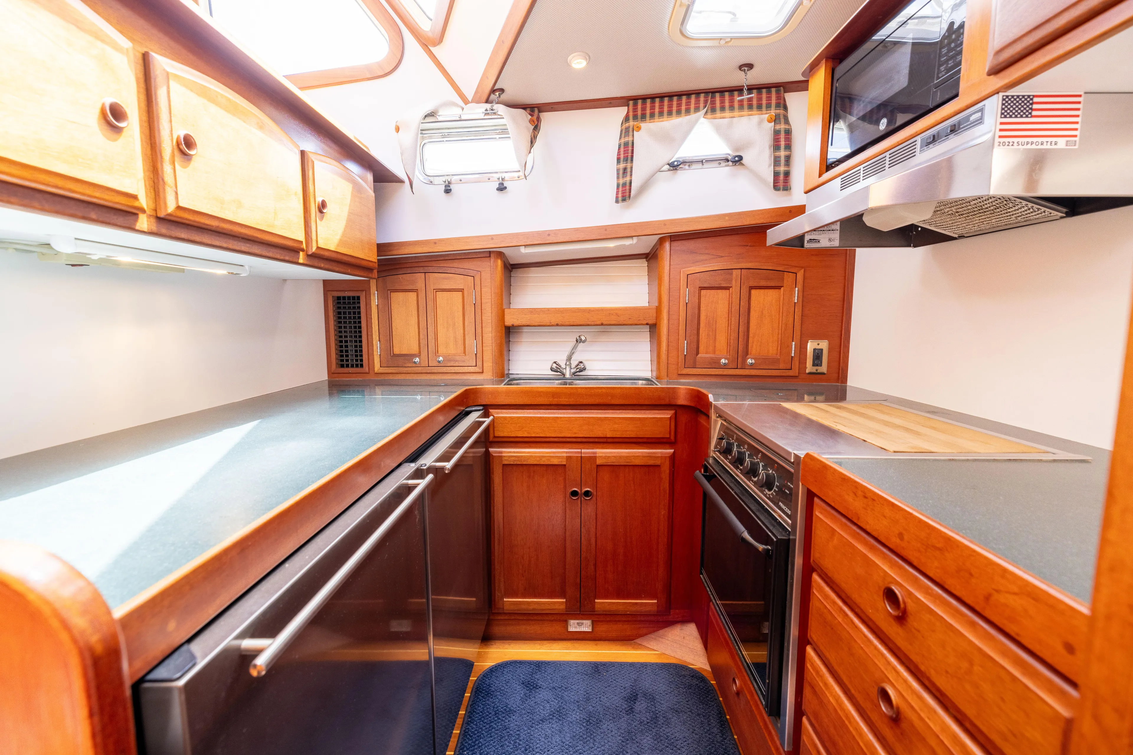 Nellie Yacht Photos Pics 1998 Sabreline 47 Aft Cabin Trawler kitchen with wood cabinetry and modern appliances.