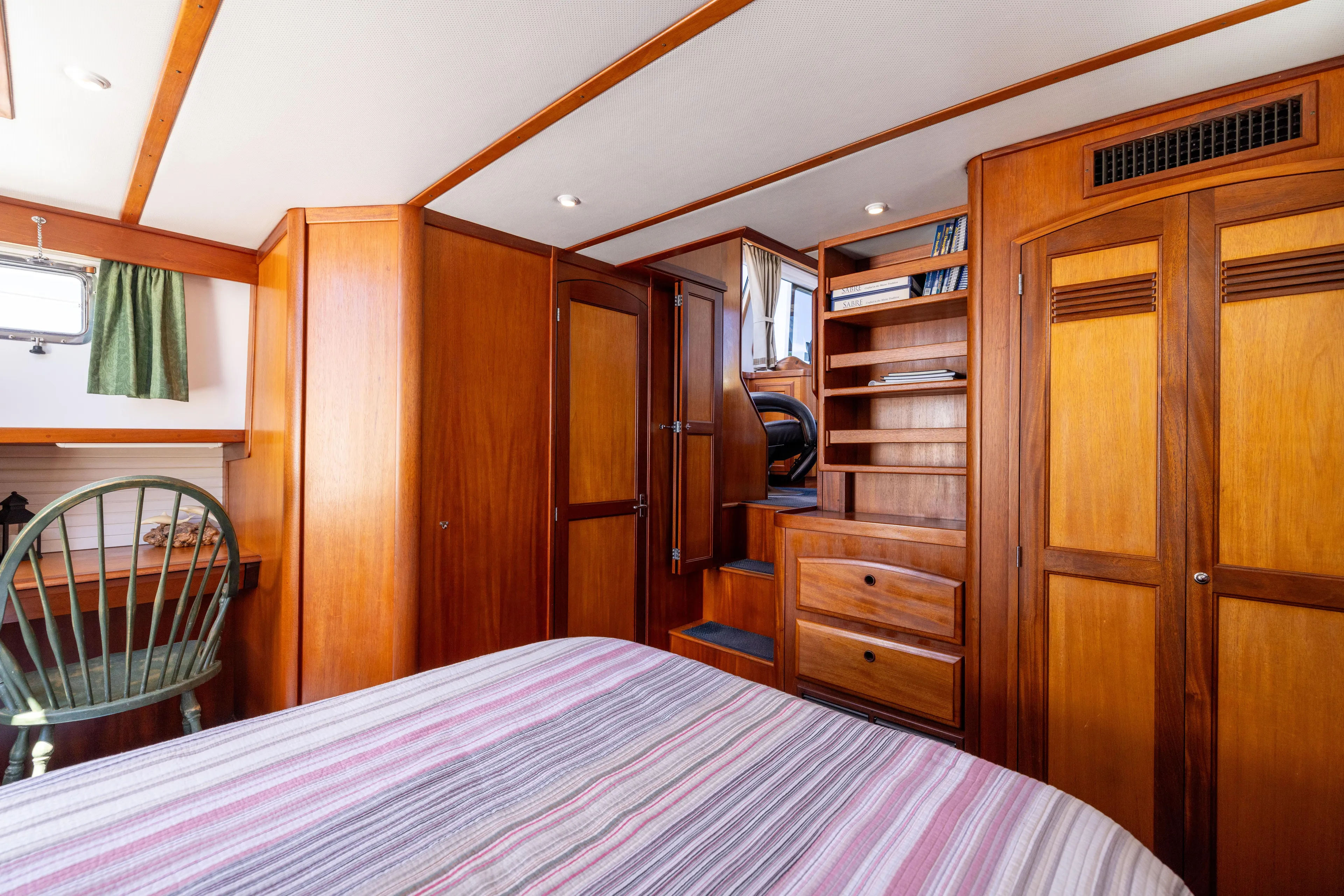 Nellie Yacht Photos Pics 1998 Sabreline 47 Aft Cabin Trawler interior with wooden cabinetry and cozy bedroom.