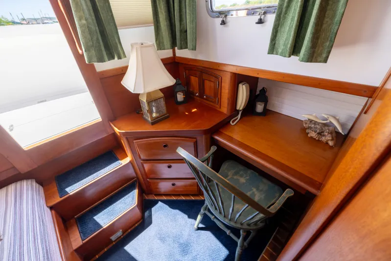 Nellie Yacht Photos Pics Cozy cabin interior of 1998 Sabreline 47 Aft Cabin Trawler with desk and chair.