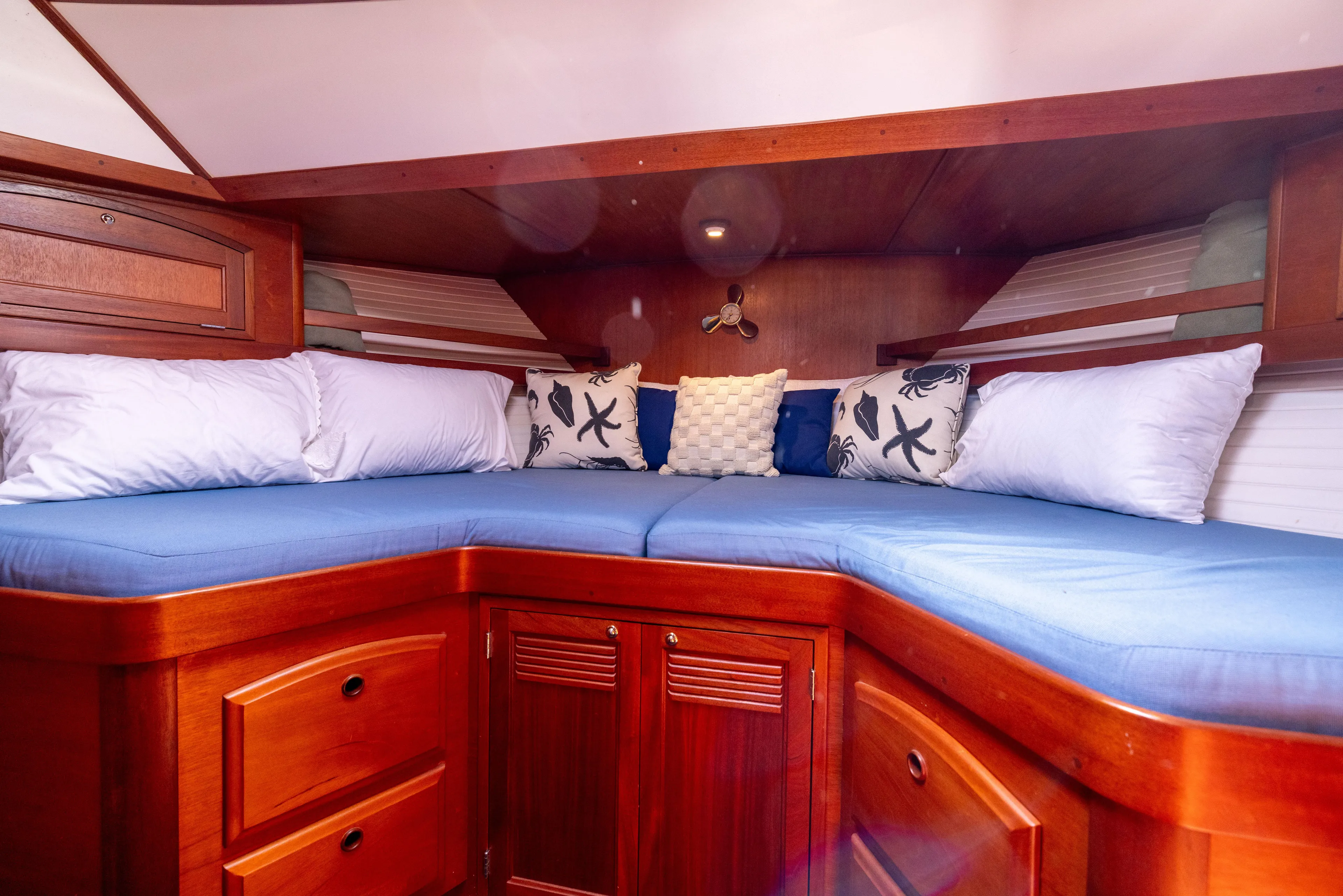 Nellie Yacht Photos Pics 1998 Sabreline 47 Aft Cabin Trawler interior with cozy bedding and wooden cabinetry.