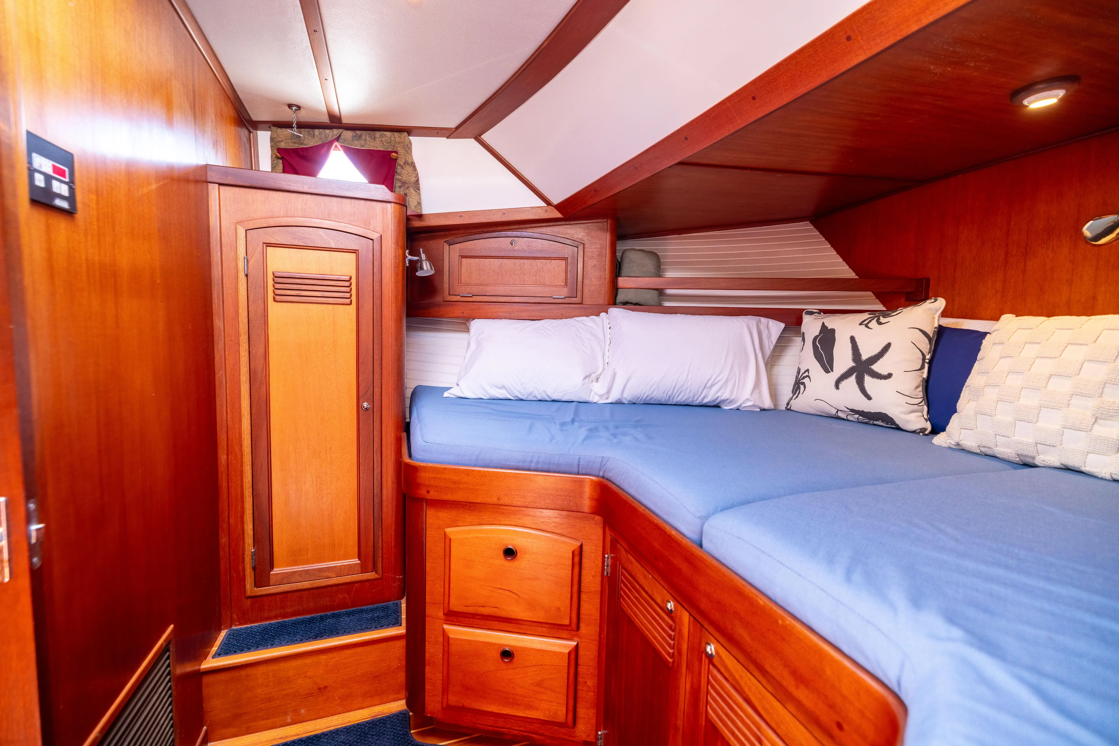 Nellie Yacht Photos Pics Cozy cabin interior of 1998 Sabreline 47 Aft Cabin Trawler with wooden furnishings.