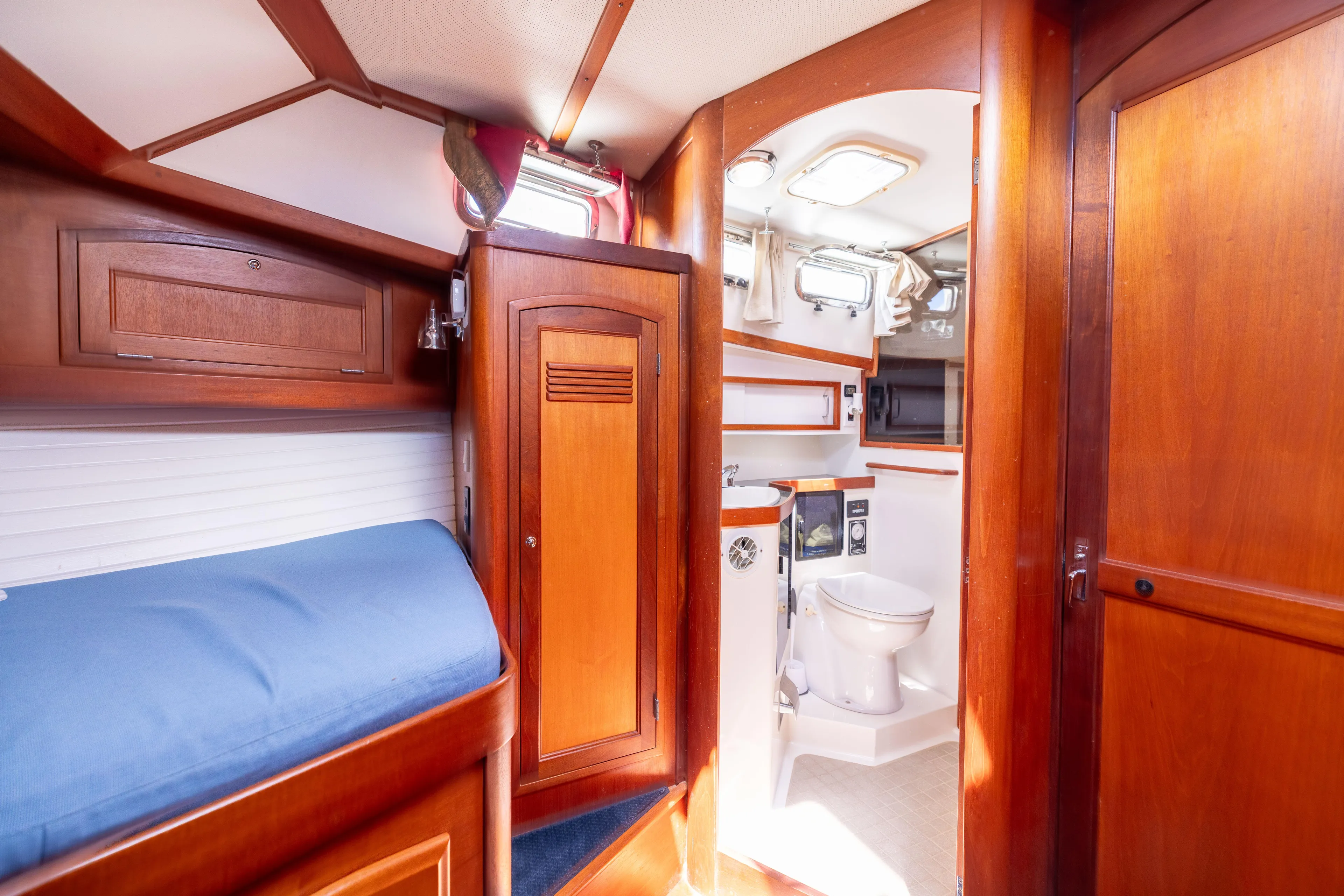 Nellie Yacht Photos Pics 1998 Sabreline 47 Aft Cabin Trawler interior with wooden cabinetry and compact bathroom.