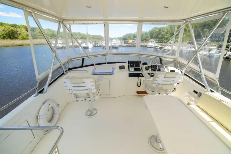Nellie Yacht Photos Pics 1998 Sabreline 47 Aft Cabin Trawler helm with dual seats, overlooking marina.