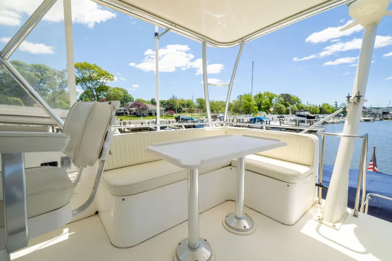 Nellie Yacht Photos Pics 1998 Sabreline 47 Aft Cabin Trawler with outdoor seating, docked at a marina under a clear sky.