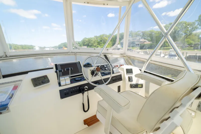 Nellie Yacht Photos Pics 1998 Sabreline 47 Aft Cabin Trawler helm with steering wheel and navigation equipment.