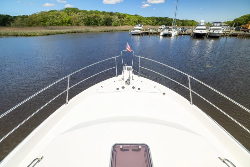 Nellie Yacht Photos Pics Sabreline 47 Aft Cabin Trawler, 1998, docked in a serene marina setting.