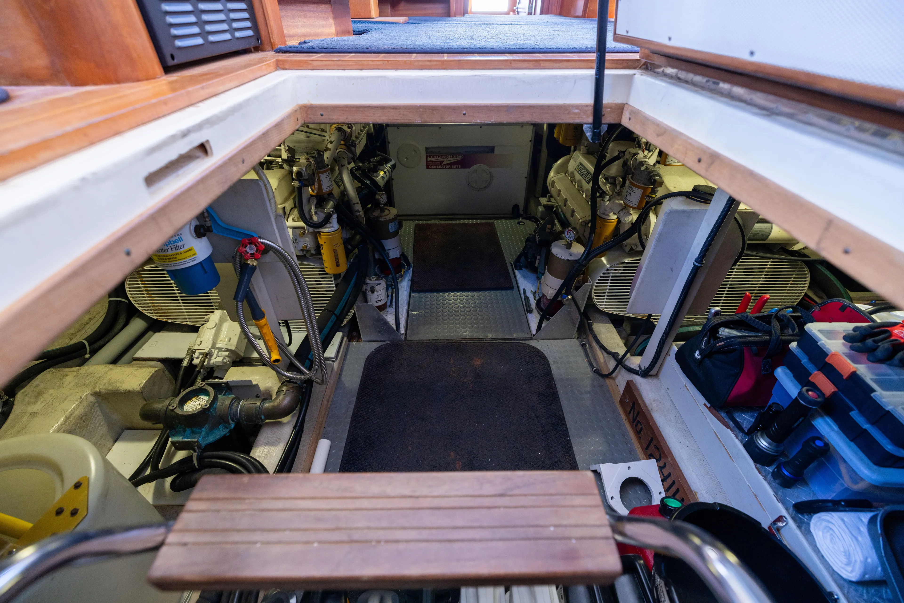 Nellie Yacht Photos Pics Engine room of 1998 Sabreline 47 Aft Cabin Trawler, showcasing equipment and storage.