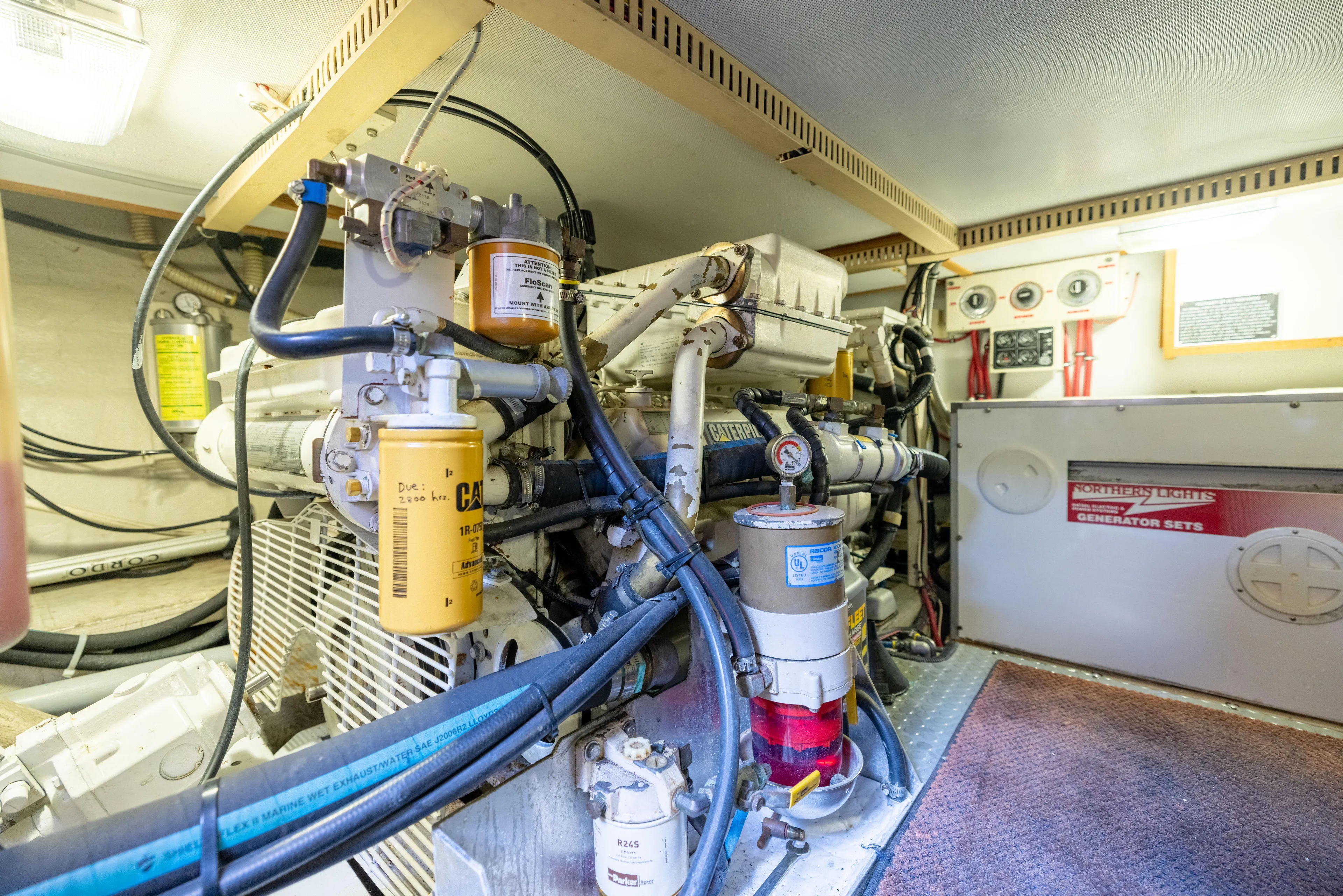 Nellie Yacht Photos Pics Engine room of 1998 Sabreline 47 Aft Cabin Trawler with visible machinery and components.