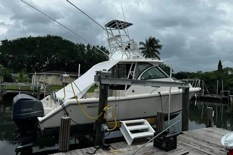  Yacht Photos Pics 2014 Pursuit OS 345 Offshore boat docked, featuring Yamaha outboard motor, under cloudy skies.