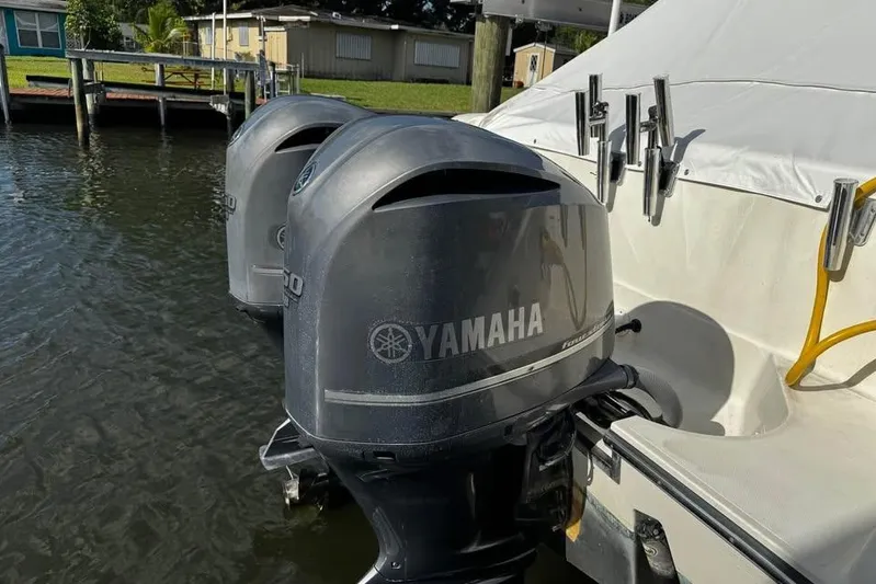  Yacht Photos Pics Twin Yamaha outboard motors on a 2014 Pursuit OS 345 Offshore boat docked by water.