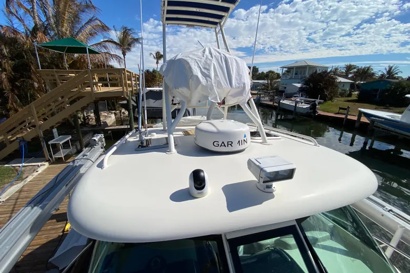  Yacht Photos Pics 2014 Pursuit OS 345 Offshore boat docked, featuring Garmin equipment under a clear sky.