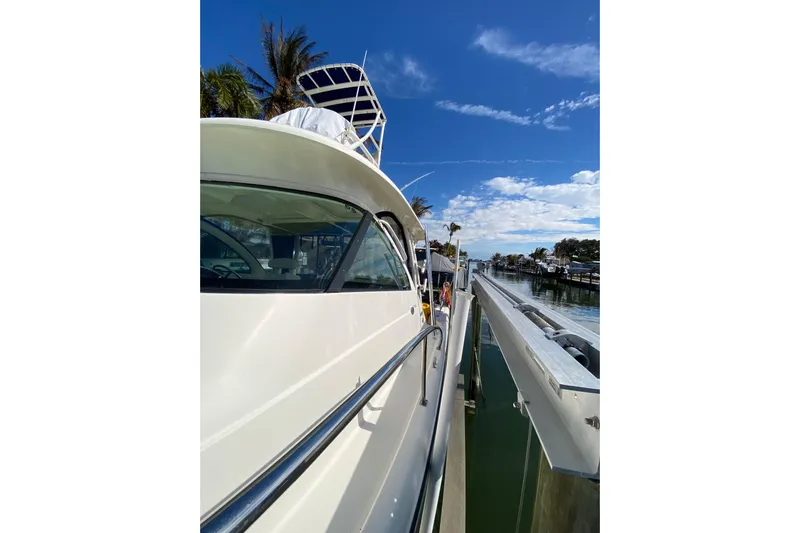  Yacht Photos Pics 2014 Pursuit OS 345 Offshore boat docked under a clear blue sky.
