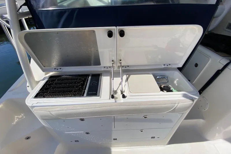  Yacht Photos Pics Outdoor kitchen on 2014 Pursuit OS 345 Offshore boat with grill and sink.