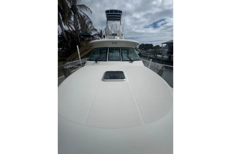  Yacht Photos Pics 2014 Pursuit OS 345 Offshore boat docked, showcasing sleek design and spacious deck.