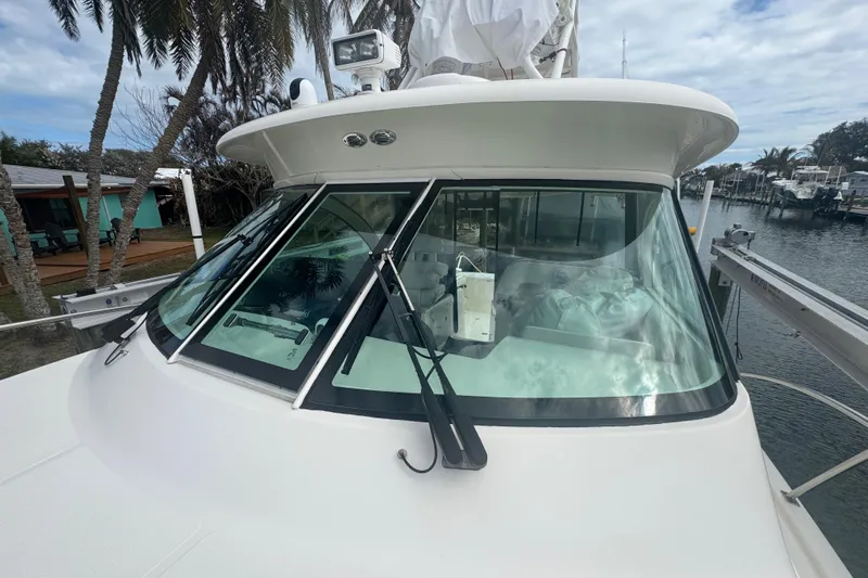  Yacht Photos Pics 2014 Pursuit OS 345 Offshore boat with sleek windshield and marina backdrop.