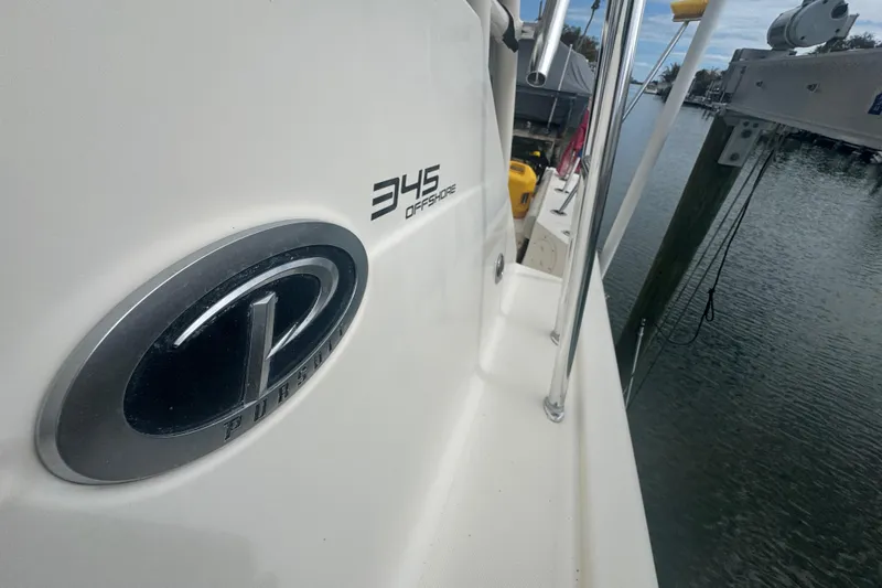  Yacht Photos Pics 2014 Pursuit OS 345 Offshore boat docked by the water.