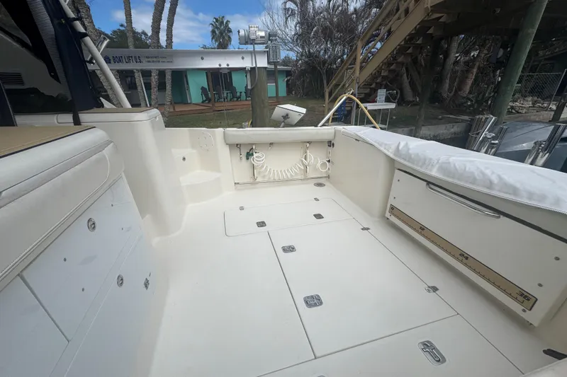  Yacht Photos Pics 2014 Pursuit OS 345 Offshore boat deck with storage compartments and seating.