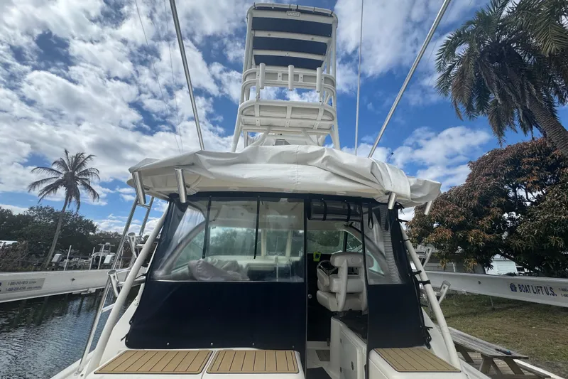  Yacht Photos Pics 2014 Pursuit OS 345 Offshore boat docked under a partly cloudy sky.
