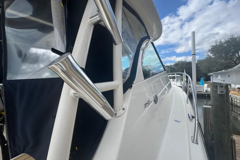  Yacht Photos Pics 2014 Pursuit OS 345 Offshore boat docked, showcasing sleek design and stainless steel features.