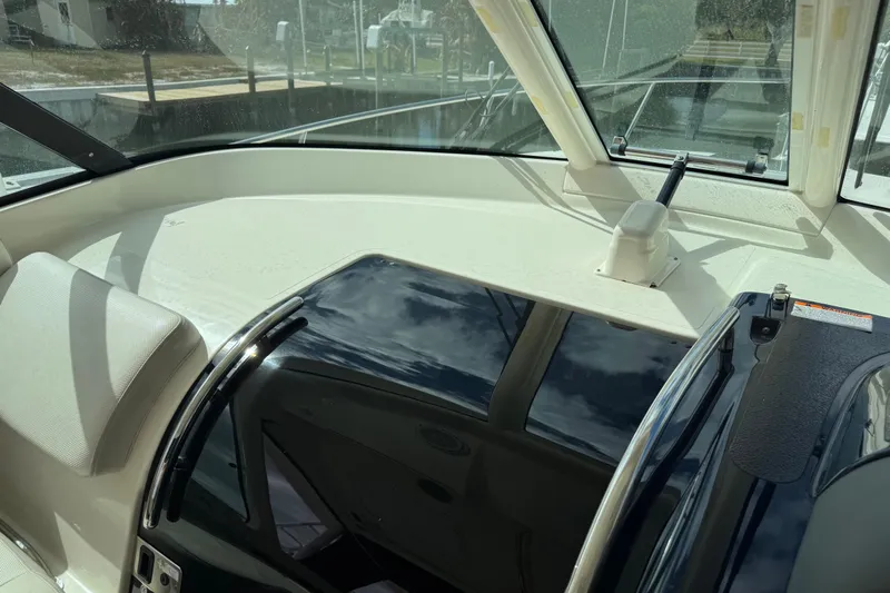  Yacht Photos Pics 2014 Pursuit OS 345 Offshore boat interior with windshield and seating.