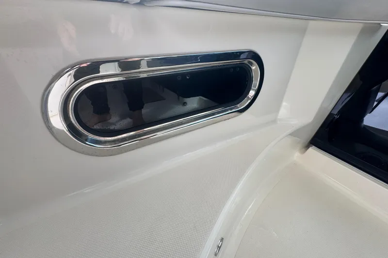  Yacht Photos Pics 2014 Pursuit OS 345 Offshore boat interior with chrome-trimmed porthole detail.