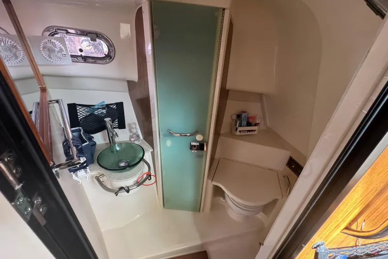  Yacht Photos Pics 2014 Pursuit OS 345 Offshore boat bathroom with sink, toilet, and storage.