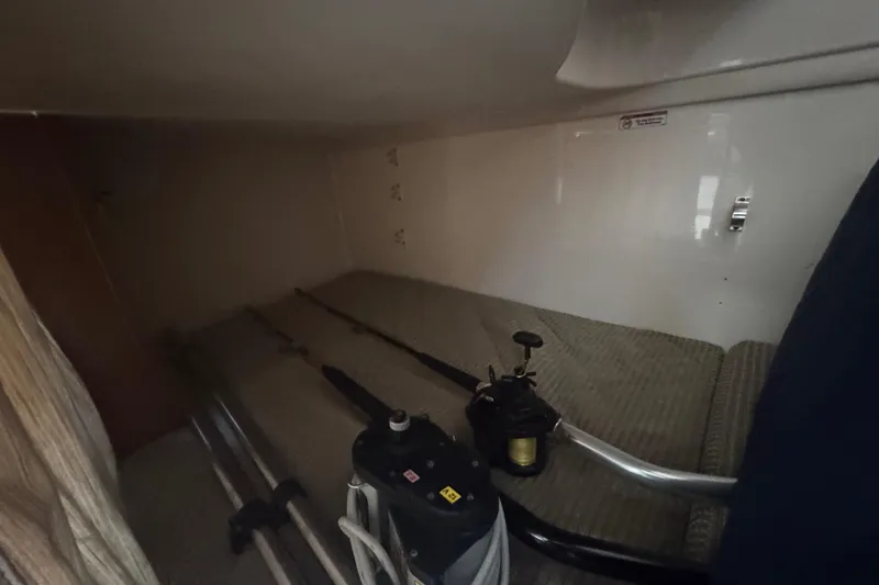  Yacht Photos Pics 2014 Pursuit OS 345 Offshore cabin interior with fishing gear storage.