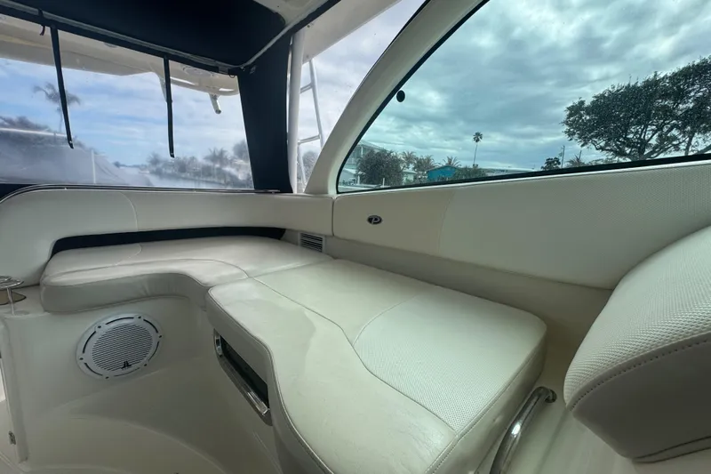  Yacht Photos Pics Interior of 2014 Pursuit OS 345 Offshore boat with white seating and window view.