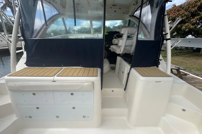 Yacht Photos Pics 2014 Pursuit OS 345 Offshore boat interior with seating and storage compartments.