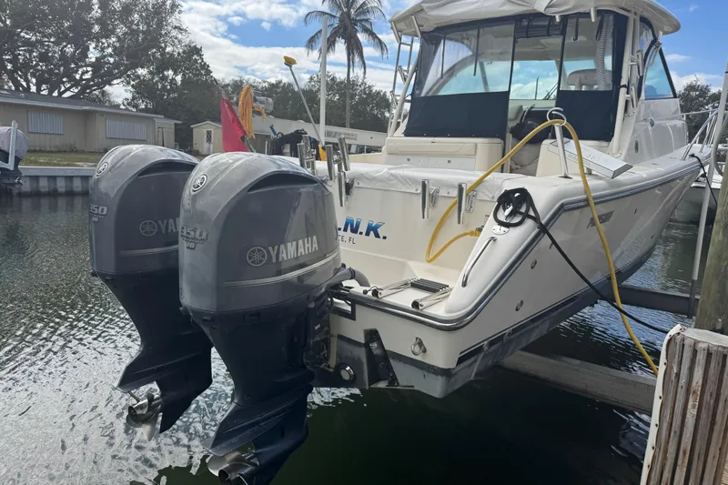  Yacht Photos Pics 2014 Pursuit OS 345 Offshore boat with dual Yamaha outboard engines docked in marina.
