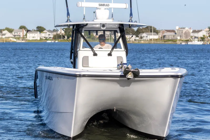  Yacht Photos Pics 2020 Freeman 34VH boat cruising on a calm lake near residential area.