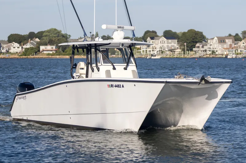  Yacht Photos Pics Freeman 34VH 2020 boat cruising on water near coastal homes.