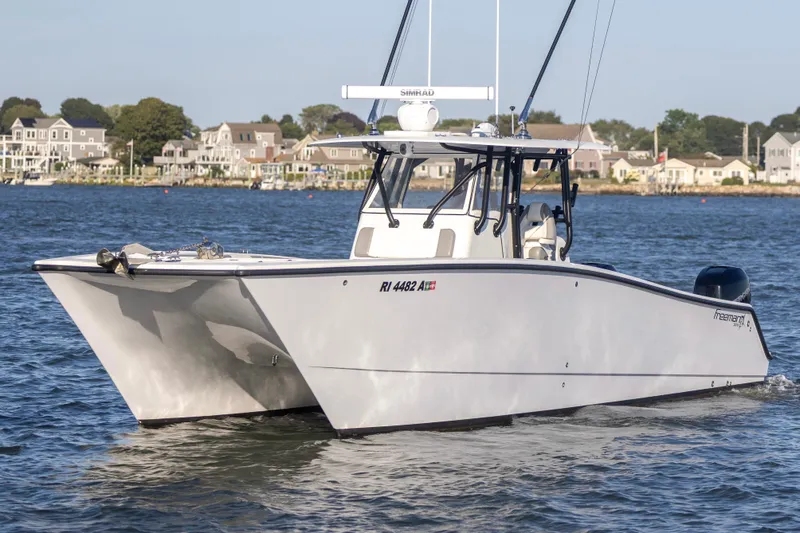  Yacht Photos Pics 2020 Freeman 34VH boat cruising on water near coastal homes.